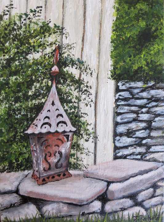 Garden Lantern No. 2 – Original Gouache Painting.
Bring a warm touch of countryside charm into your home with Garden Lantern No. 1. Inspired by a visit to the historic Falstone Barns near Kielder Dam in Northumberland, this original piece captures the serene atmosphere of rural England with exquisite detail in the rustic stonework and soft glowing lantern.
Painted in gouache on canvas and sealed with a protective varnish finish, this vibrant artwork is a unique, one-of-a-kind piece signed by the artist.