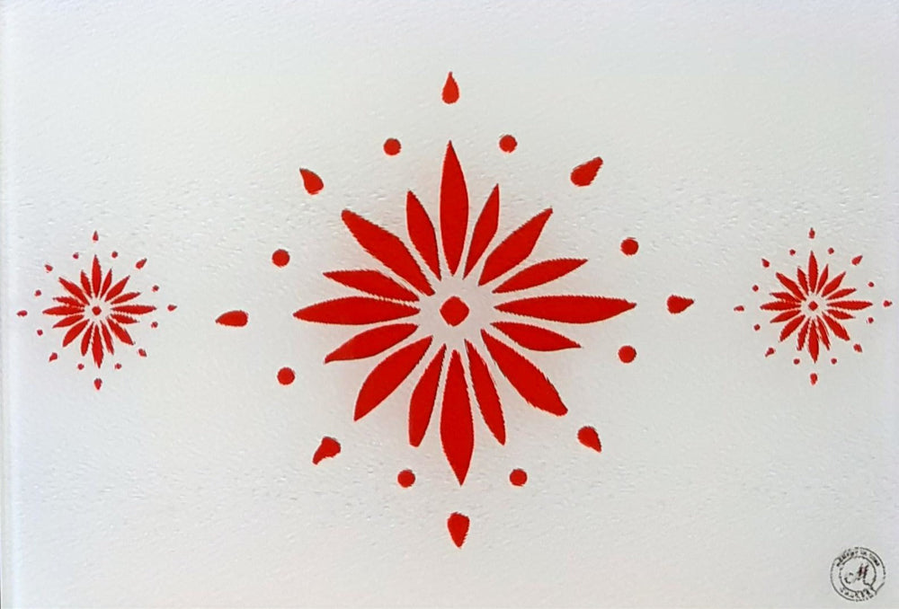 White cutting board with red flowerburst design. Board displayed on a blue background. Premium glass worktop saver and serving board. A4 size.