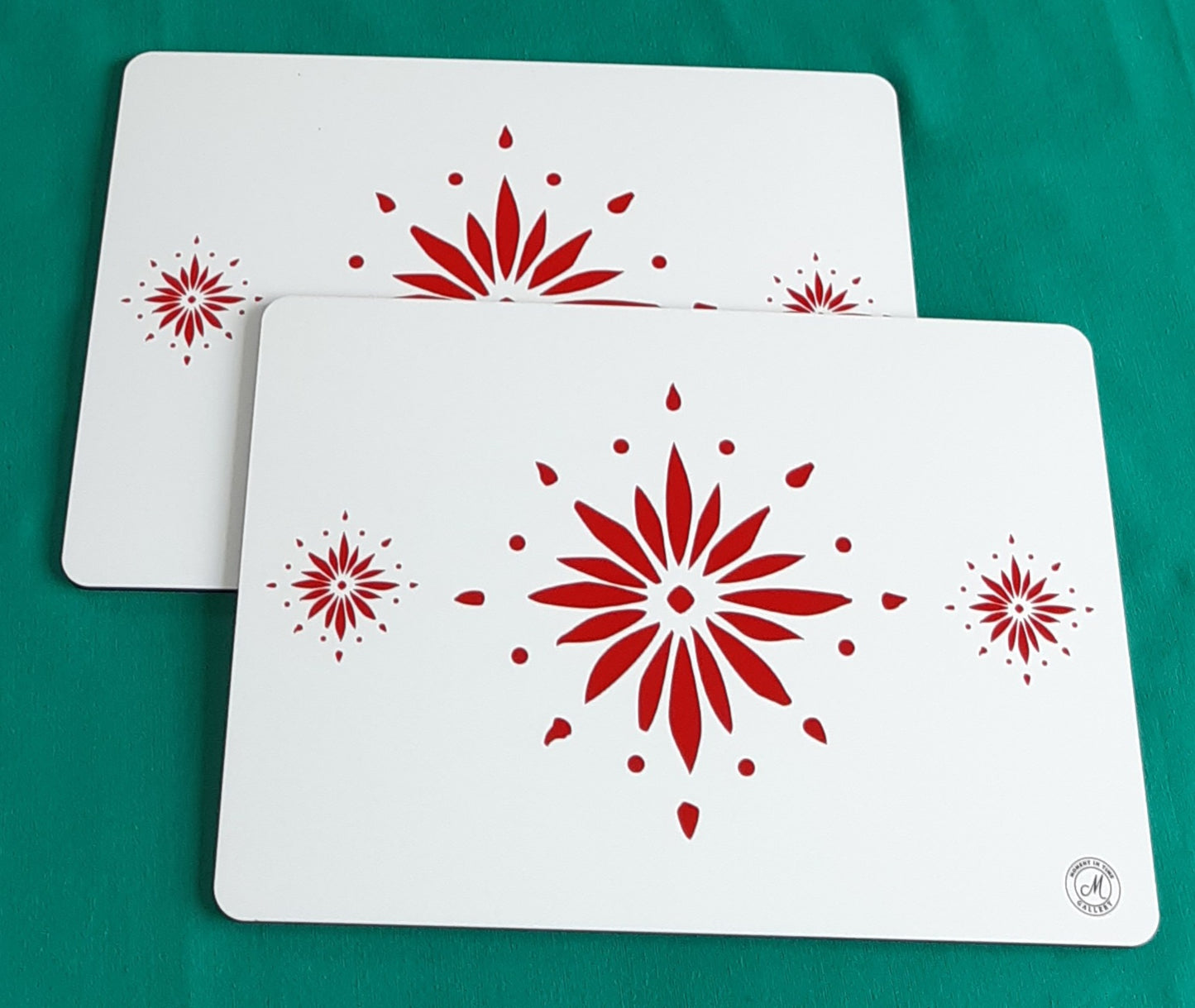 Twin set white table mats with red  decorative flowerburst design. Heat resistant place mats.