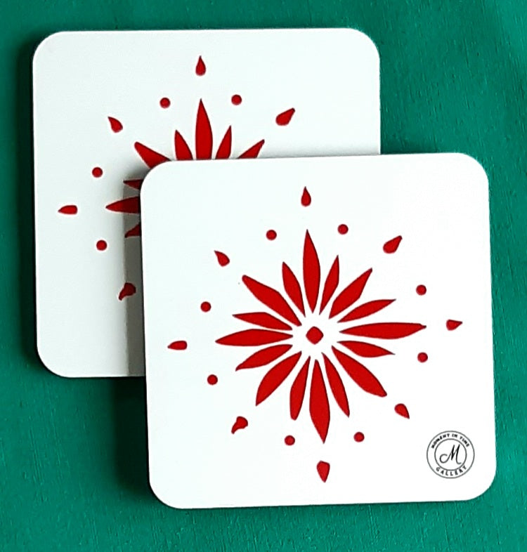 Twin set square coasters with red flowerburst design on a white background, featuring a brand logo in the corner. Heat resistant coaters.