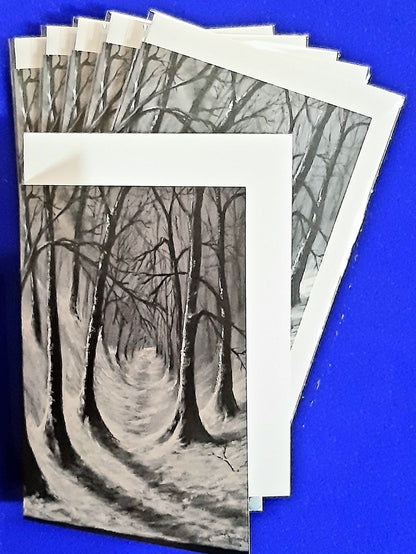 Christmas cards. Woodland Trail MTGP-2057 Pack size x6 or x12
An atmospheric view of a deep woodland snowy trail in varying shades of bluey greys and casting shadows on the ground. Cards folded vertically on the left, includes white envelope and cello packaging. Blank inside for your personal messages and memories to be added, Size 5 x 7 inch
