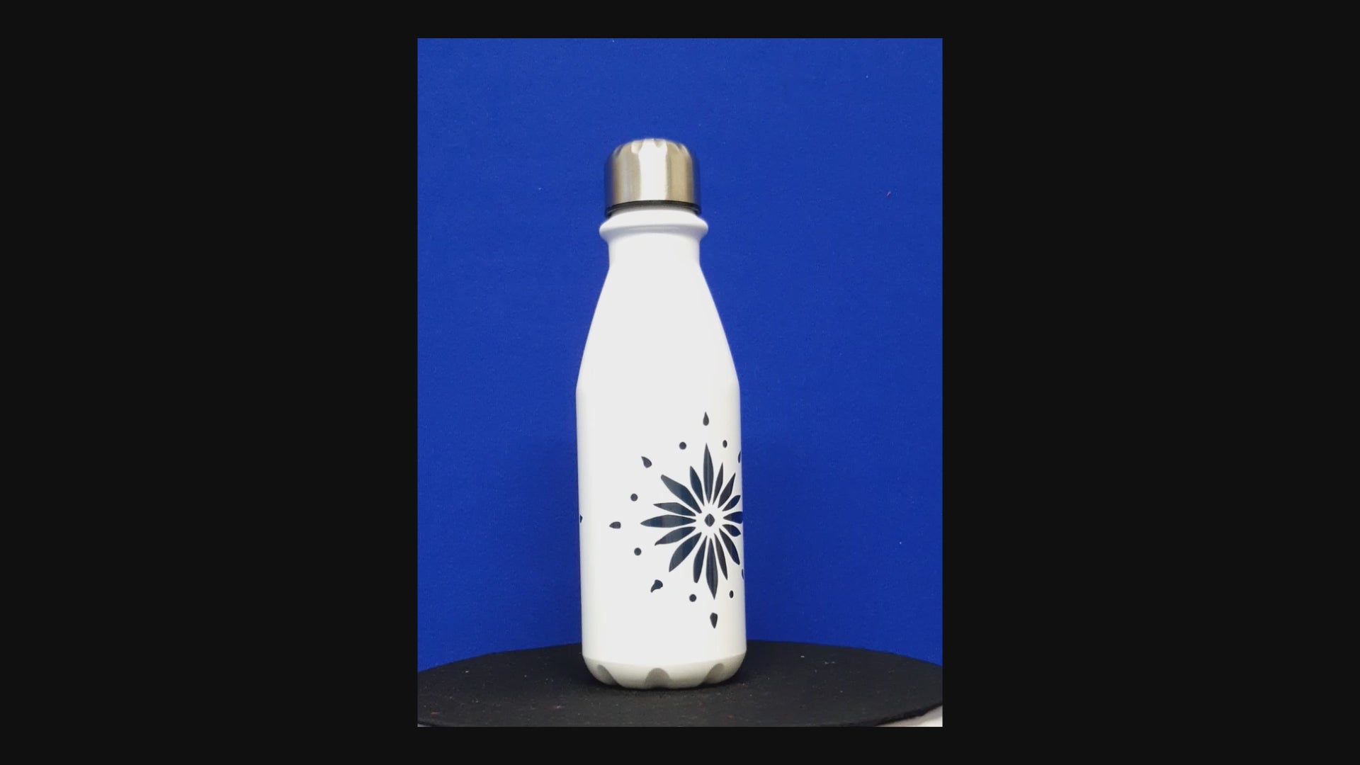 Aluminium Flowerburst bottle. White coating with a red or blue flowerburst design on the front and back of the bottle. Silver cup cap. Flowerburst bottle.
Exclusively designed by Moment in Time Gallery. 650 ml Designer hydration.