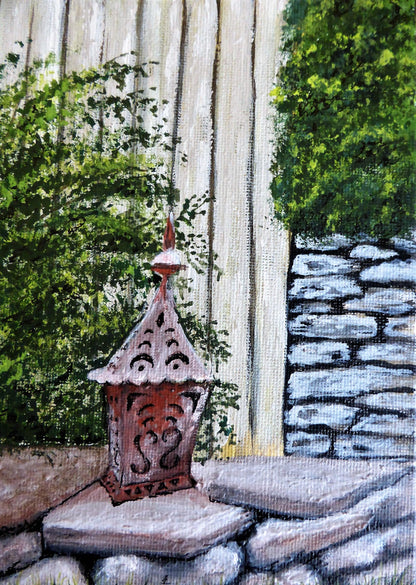 Garden Lantern No. 1 – Original Gouache Painting.
Bring a warm touch of countryside charm into your home with Garden Lantern No. 1. Inspired by a visit to the historic Falstone Barns near Kielder Dam in Northumberland, this original piece captures the serene atmosphere of rural England with exquisite detail in the rustic stonework and soft glowing lantern.
Painted in gouache on canvas and sealed with a protective varnish finish, this vibrant artwork is a unique, one-of-a-kind piece signed by the artist.