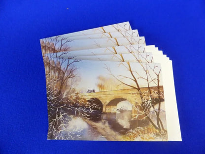 Christmas Cards, Pack of 6 Winter Tyne Bridge
Print of an original watercolour artwork by Joanne Roberts,  Reflective winter view of the Tyne Bridge in Bellingham, in Northumberland, UK.  Pack of 6 or 12 cards, folded horizontally on the top, includes white envelope and cello packaging. Blank inside for your personal messages and memories to be added. Size 5 x 7 inch